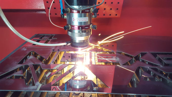 A machine cutting letters out of metal